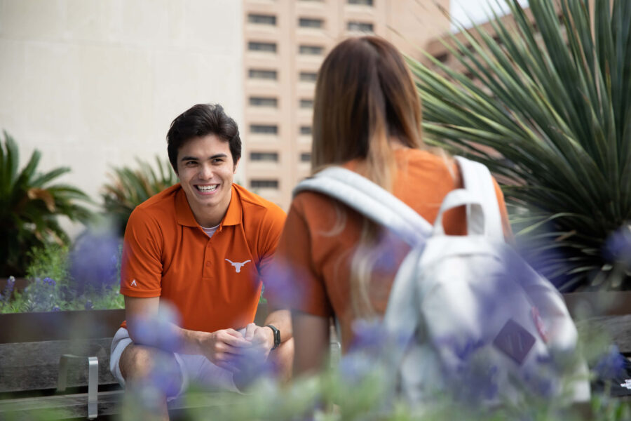 Photo of two students talking on campus.