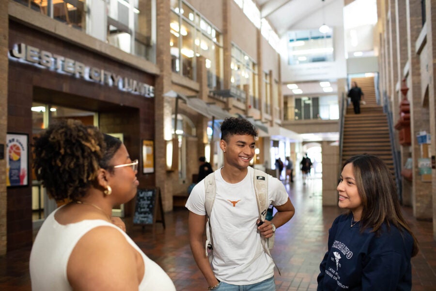 Students talking inside a residential hall.